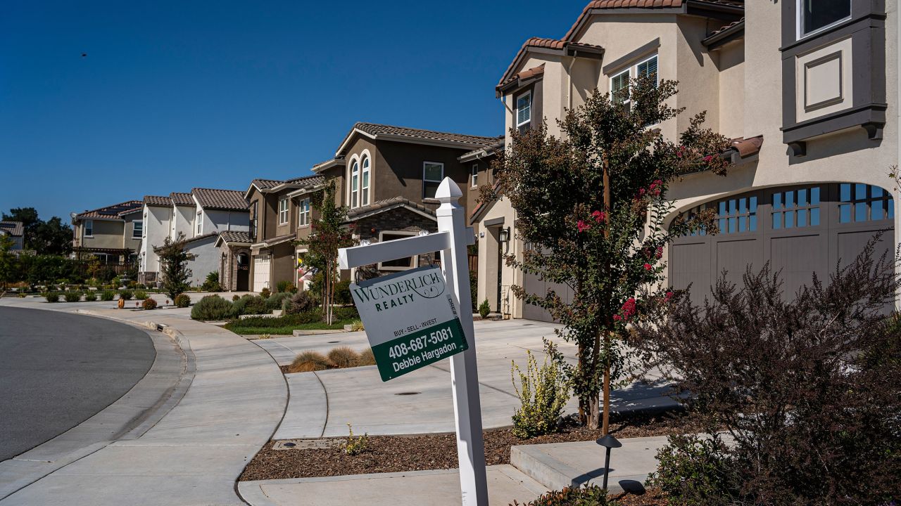 A real estate sign outside a home in Morgan Hill, California, on October 4, 2022. Housing prices in the US soared during the pandemic, making it harder for millennials to buy homes. 