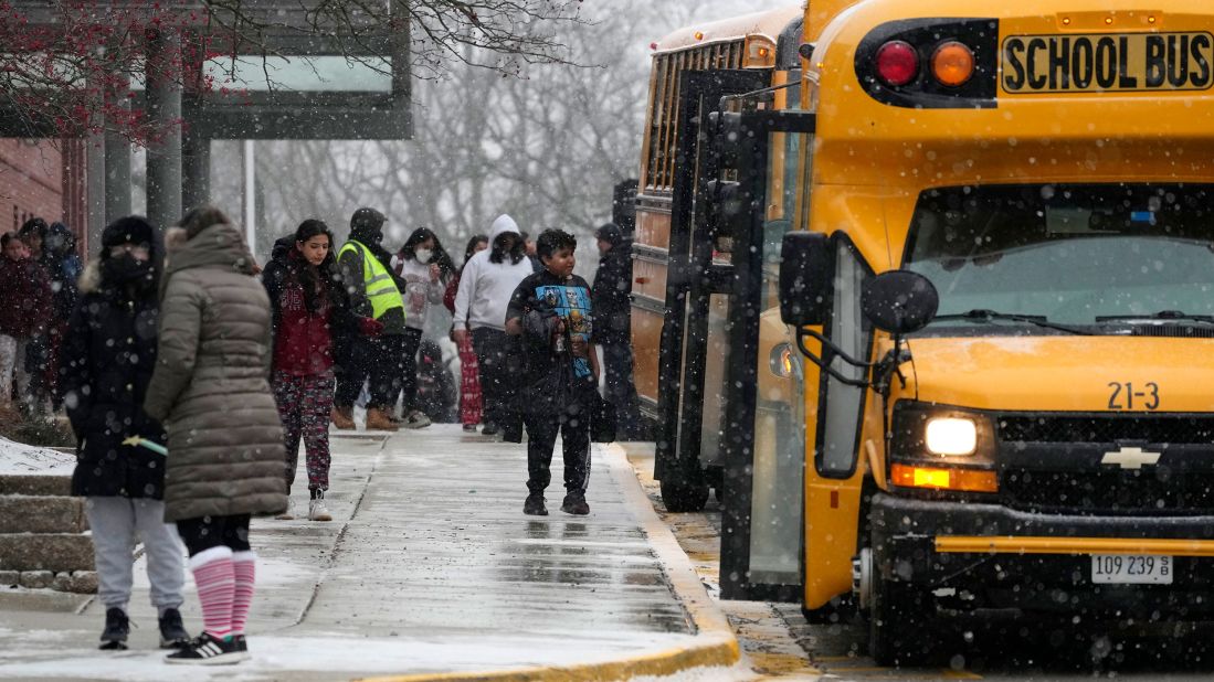 Students walk to school buses after early dismissal at a middle school in Wheeling, Illinois, on December 22.