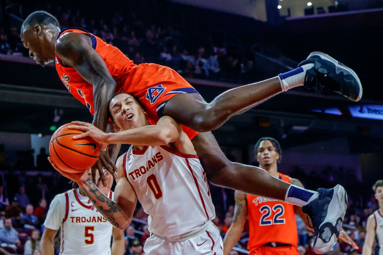 Auburn's Jaylin Williams falls on Southern California's Kobe Johnson during their NCAA basketball game on Sunday, December 18, in Los Angeles.