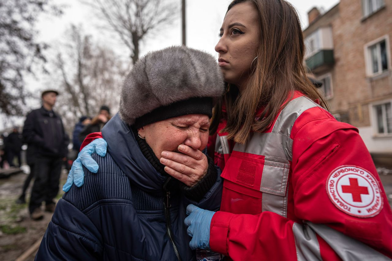 A woman cries in front of a building that was destroyed by a Russian attack in Kryvyi Rih, Ukraine, on Friday, December 16.