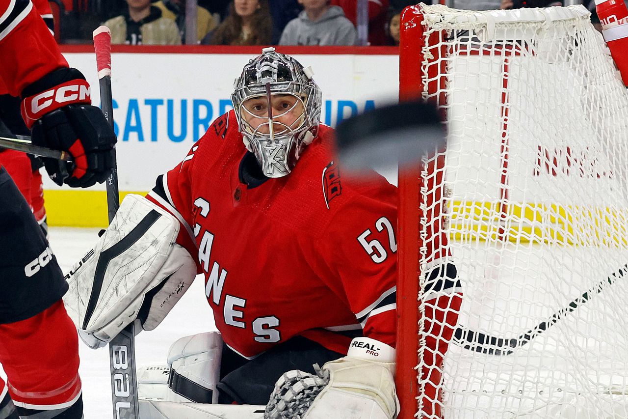 Carolina Hurricanes goalie Pyotr Kochetkov watches a deflected puck fly through the air during a game against the Pittsburgh Penguins in Raleigh, North Carolina, on Sunday, December 18.