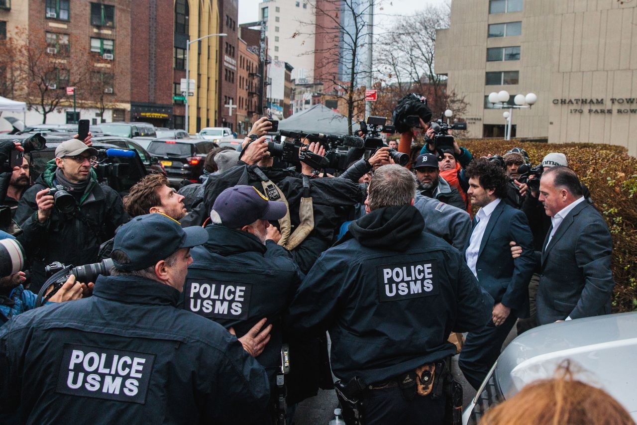 Disgraced founder of crypto exchange FTX Sam Bankman-Fried, second from right, leaves court in New York on Thursday, December 22. <a href="https://www.cnn.com/2022/12/22/business/ftx-sam-bankman-fried/index.html" target="_blank">A judge released him on a $250 million bond</a> in his first appearance on American soil since his arrest last week in the Bahamas.