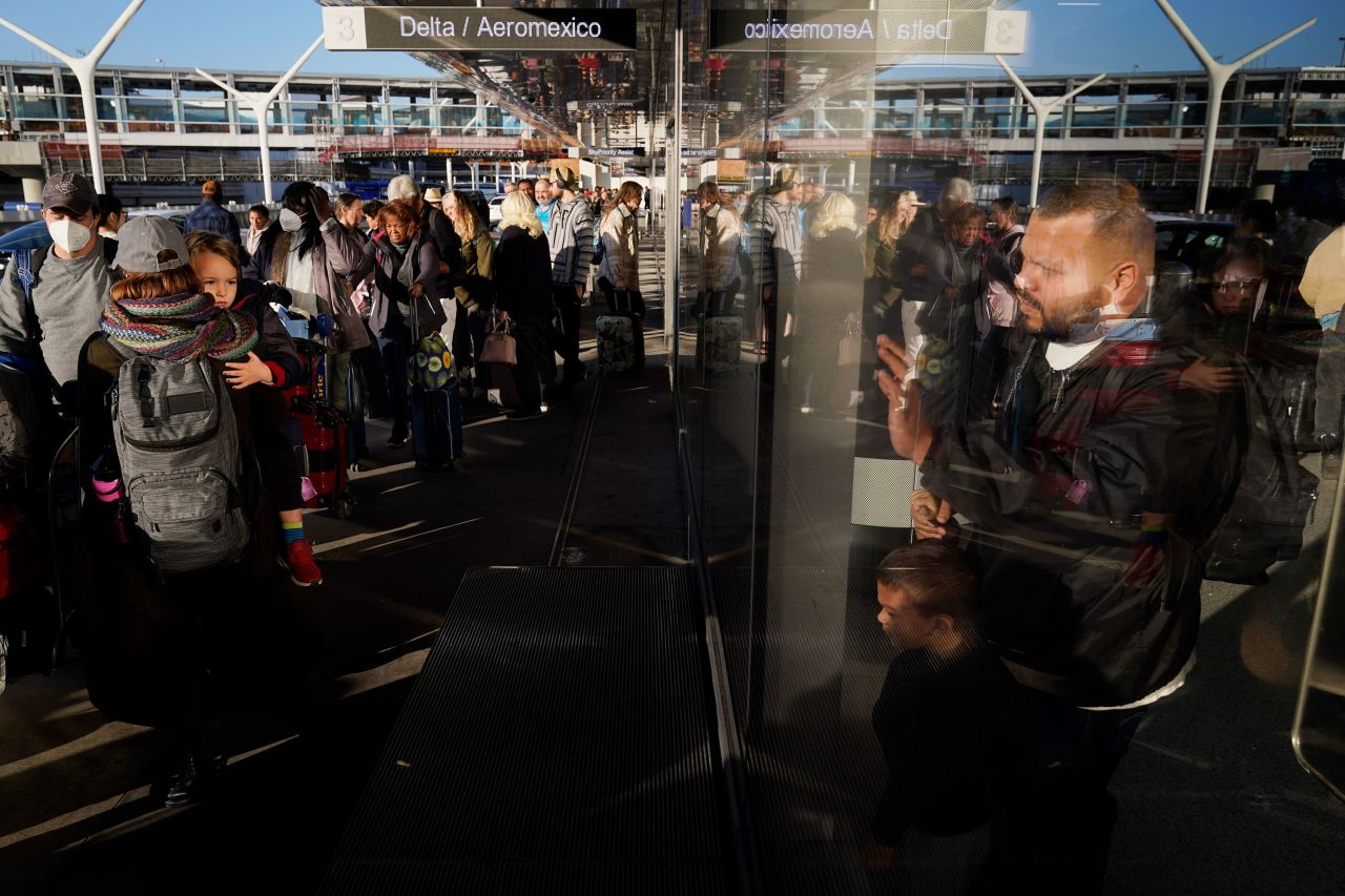 People wait to check in at Los Angeles International Airport on Monday, December 19.