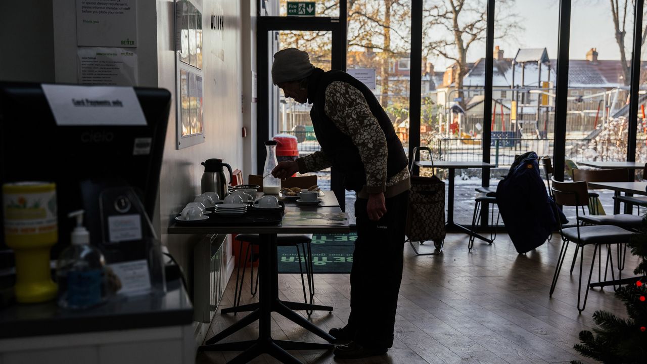 A visitor serves himself a complimentary hot drink during a "Warm Spaces And Warm Welcomes" session at the Ashburton Hall community hub in Croydon, England, on December 15.