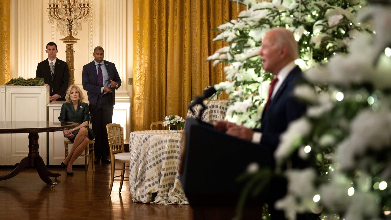 US First Lady Jill Biden (L) listens to US President Joe Biden deliver a Christmas address from the Cross Hall of the White House in Washington, DC, on December 22, 2022. (Photo by Brendan Smialowski / AFP) (Photo by BRENDAN SMIALOWSKI/AFP via Getty Images)
