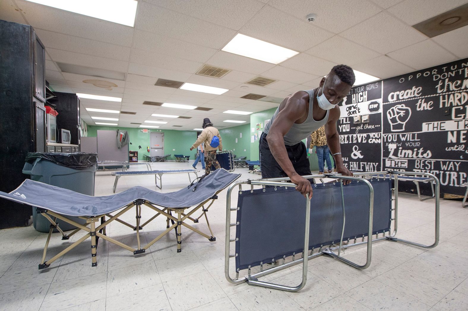 Brady Myers helps turn the Stewpot Community Services day shelter for the unhoused into an emergency overnight shelter in Jackson, Mississippi, on December 22.