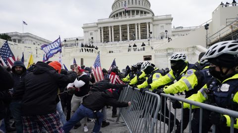 FILE - Insurrectionists loyal to President Donald Trump try to break through a police barrier, Wednesday, Jan. 6, 2021, at the Capitol in Washington. Top House and Senate leaders will present law enforcement officers who defended the U.S. Capitol on Jan. 6, 2021, with Congressional Gold Medals on Wednesday, Dec. 7, 2022, awarding them Congress's highest honor nearly two years after they fought with former President Donald Trump's supporters in a brutal and bloody attack. (AP Photo/Julio Cortez, File)
