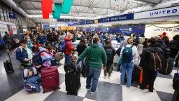 Travelers arrive for their flights at Chicago's O'Hare International Airport on December 22, 2022.