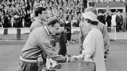 Queen Elizabeth II shake hands with Cohen at Wembley before England's first group game of the 1966 World Cup.