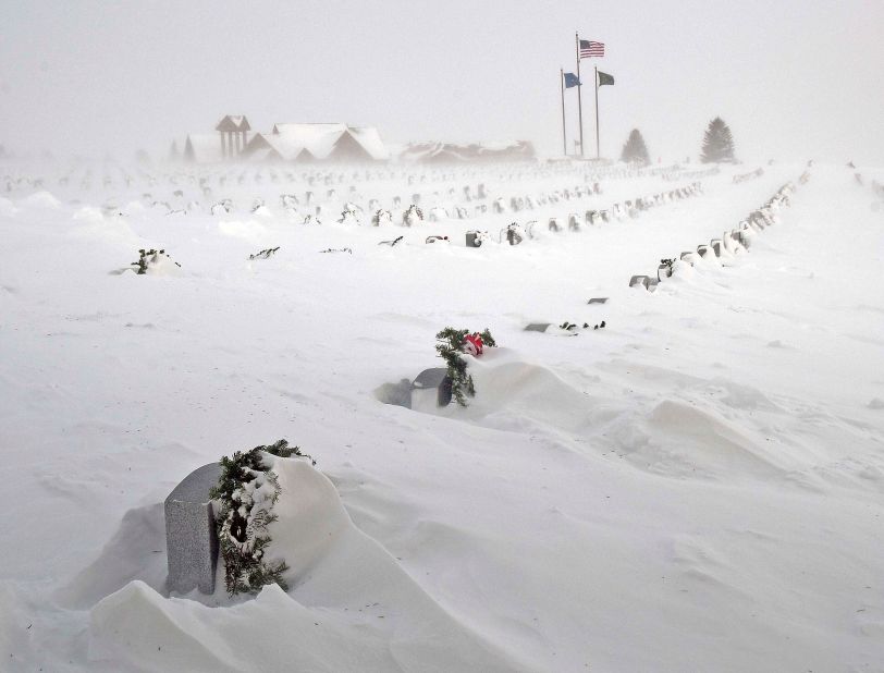 Rows of headstones at the North Dakota Veterans Cemetery are blanketed by drifting snow in Mandan on Thursday, December 22.