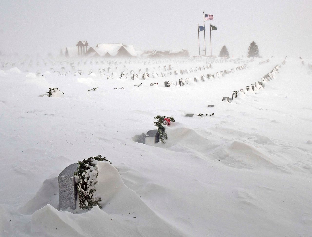 Rows of headstones at the North Dakota Veterans Cemetery are blanketed by drifting snow on Thursday, December 22, in Mandan.