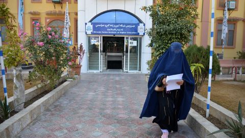 A female student walks in front of a university in Kandahar province, Afghanistan, on December 21.  The Taliban have banned university education for women across the country, drawing condemnation from the United States and the United Nations. 