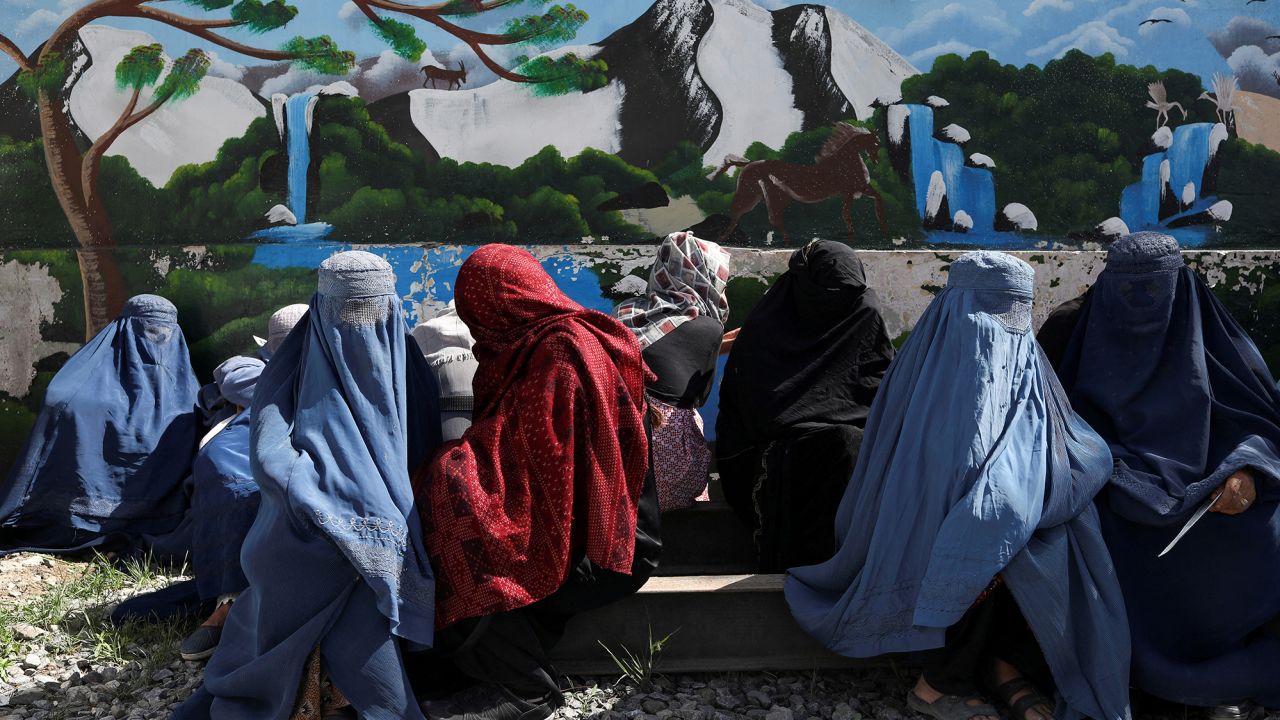 Afghan women wait to receive a food package being distributed by a Saudi Arabia humanitarian aid group at a distribution center in Kabul, Afghanistan, April 25, 2022.   