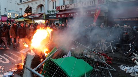 Police fired tear gas to disperse an increasingly agitated crowd in central Paris, shortly after a gunman killed three Kurds in a shooting at a community center. 