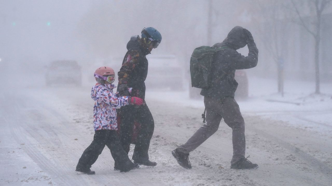 A family walks Friday across Elmwood Avenue in Buffalo, New York.