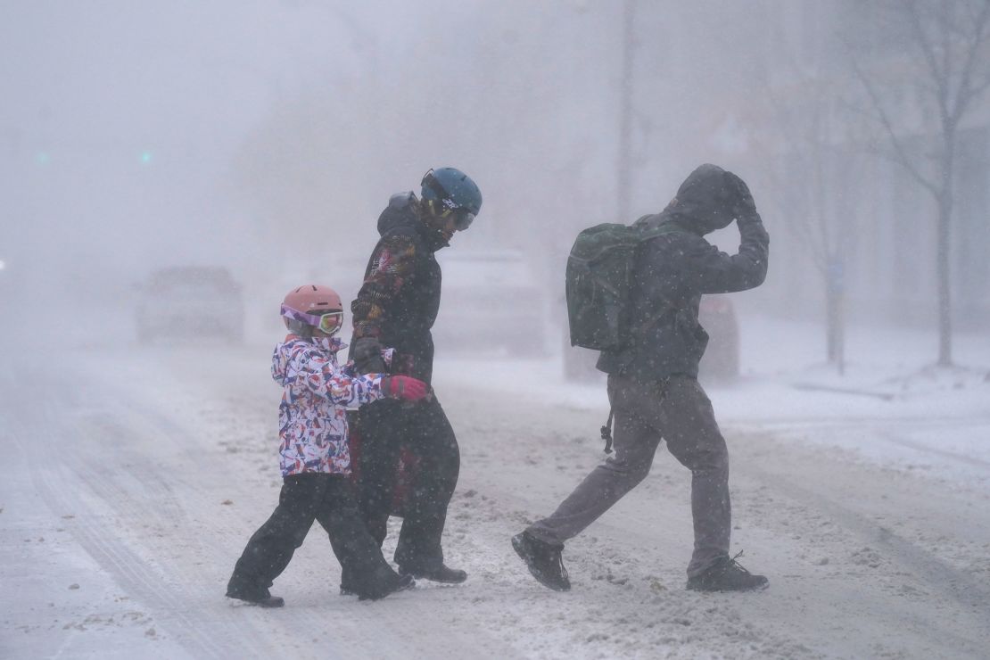 A family walks Friday across Elmwood Avenue in Buffalo, New York.