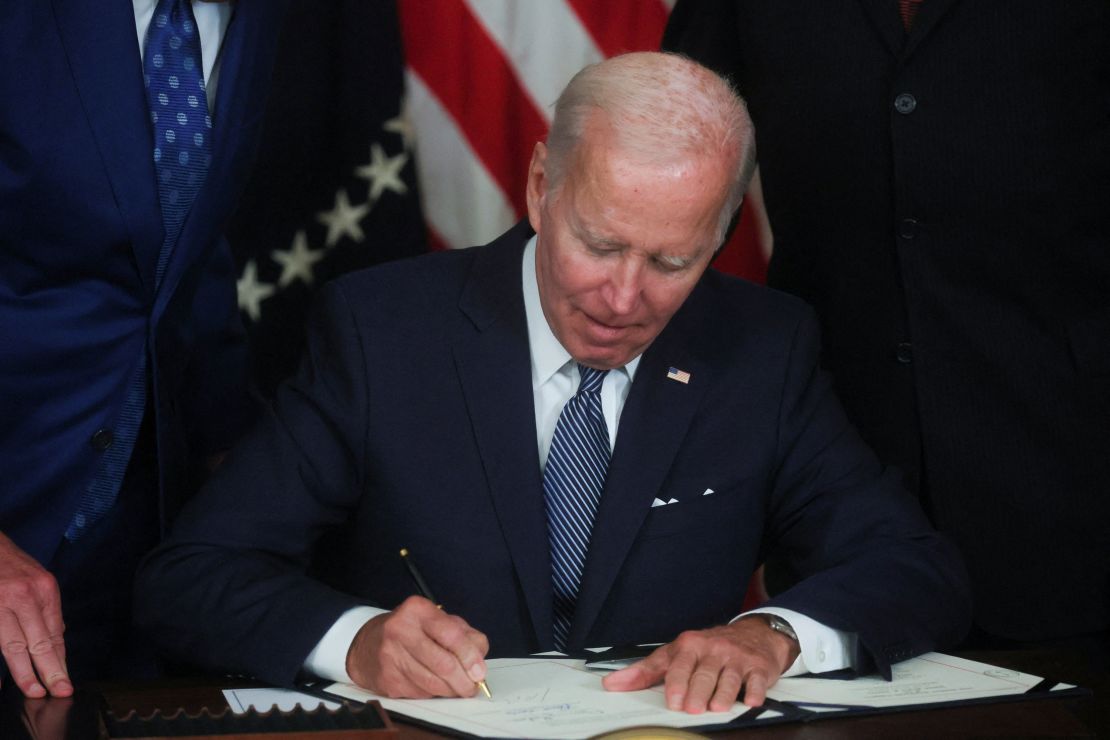 President Joe Biden signs "The Inflation Reduction Act of 2022" into law during a ceremony in the State Dining Room of the White House in August.