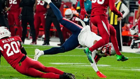Arizona Cardinals cornerback Marco Wilson (20) tackles New England Patriots wide receiver DeVante Parker (1) during the first half of an NFL football game, Monday, Dec. 12, 2022, in Glendale, Arizona.
