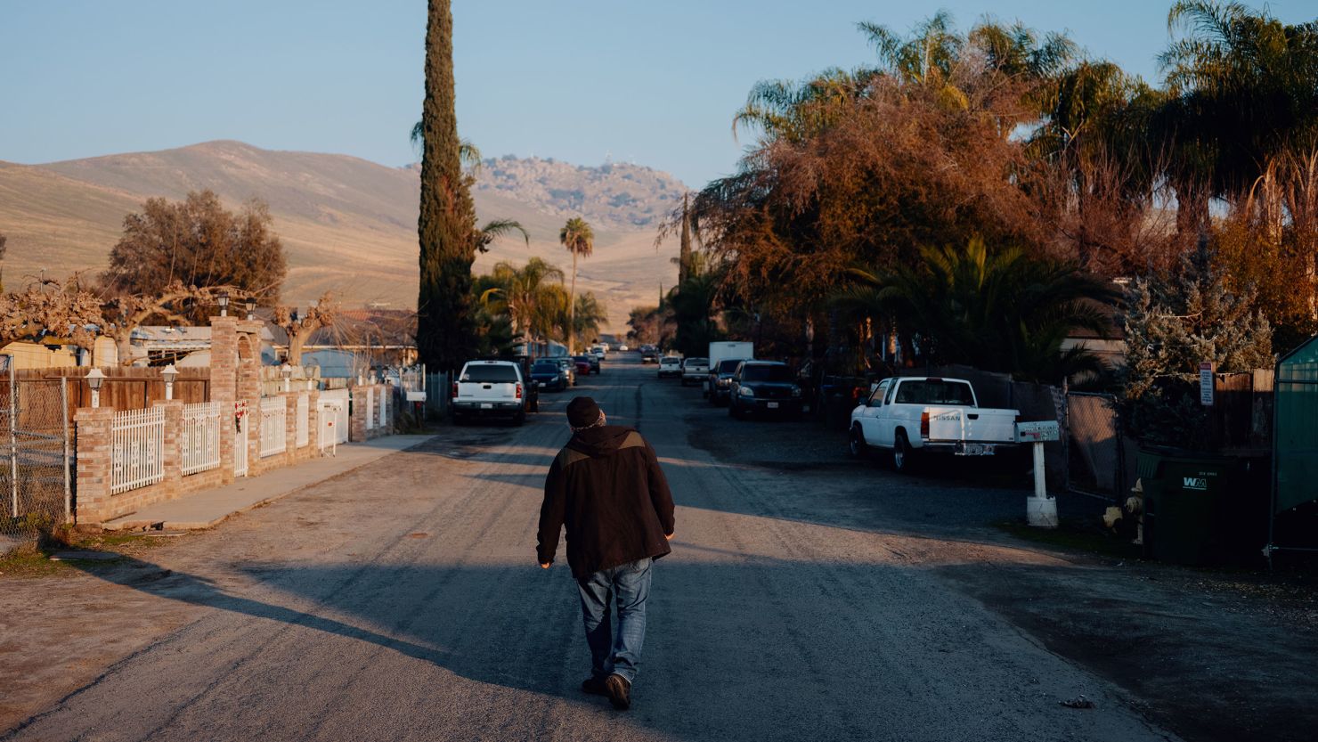 Benjamin Cuevas walks down a street in Tooleville, California. 