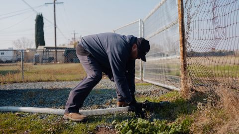 Rick Jackpot Fernandez of Kyle Koontz Water Hauling hooks up a hose to one of the town's water storage tanks.