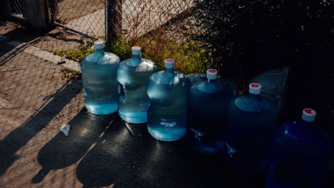 Six five-gallon jugs of water are delivered to a resident's home in Tooleville.