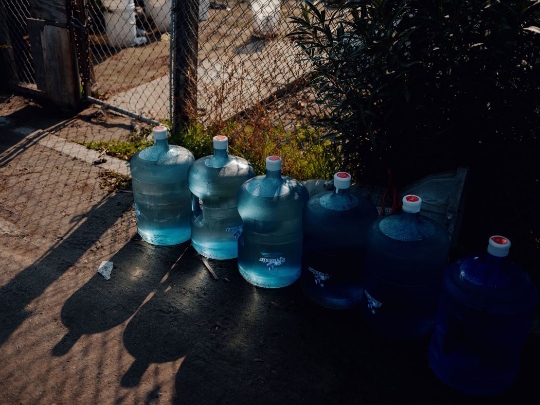 Six five-gallon jugs of water are delivered to a resident's home in Tooleville.