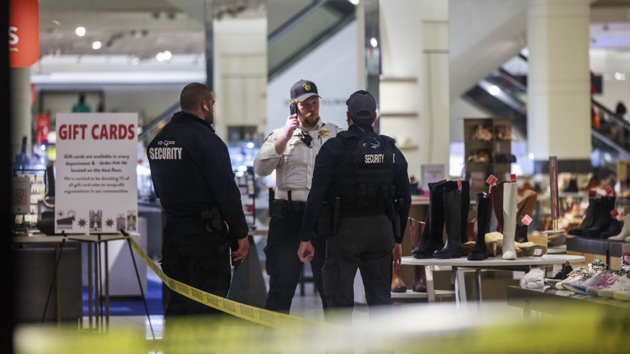 Security officers speak inside a store at the Mall of America on December 23.