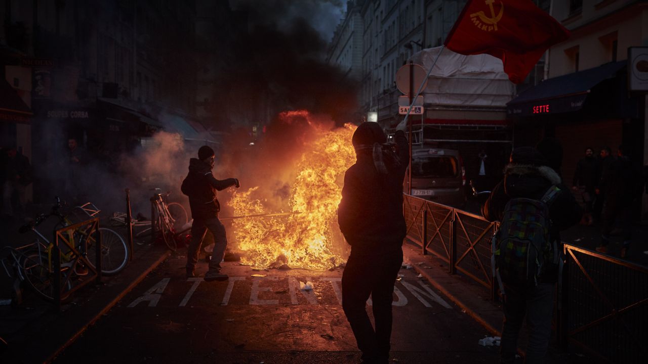 Angry protesters face off with riot police in the wake of the shooting on Friday. 