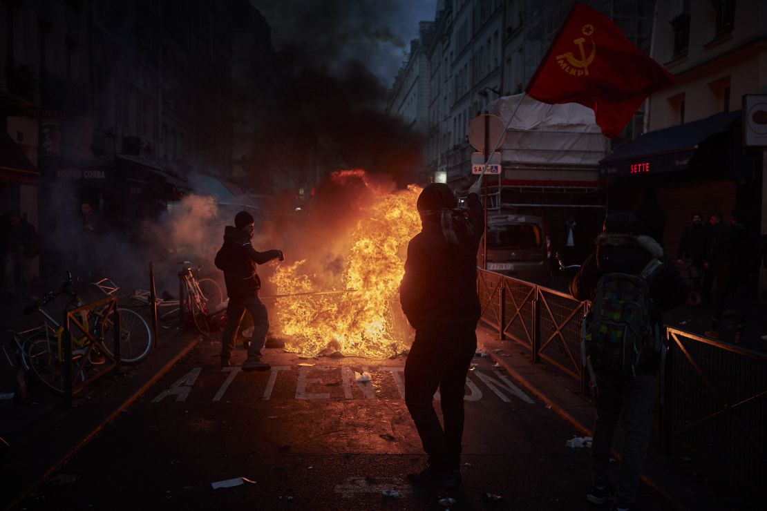 Angry protesters face off with riot police in the wake of the shooting on Friday.