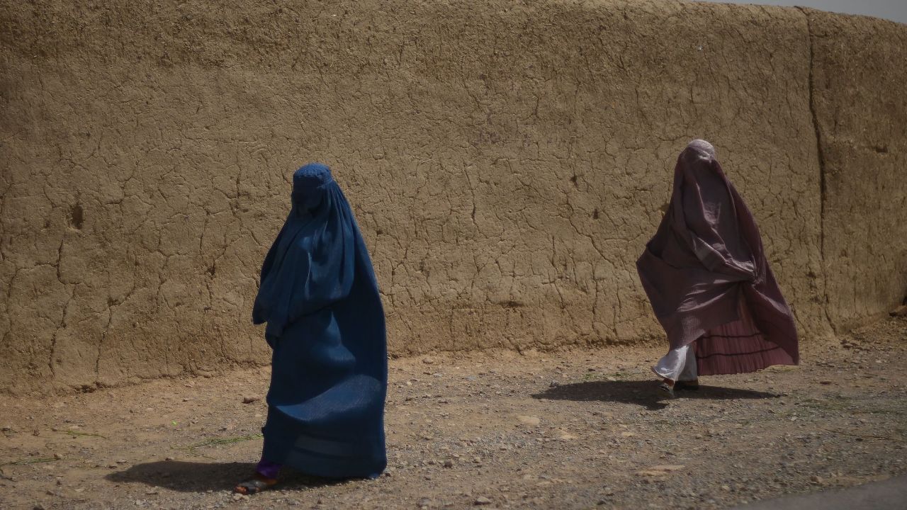 Afghan women walk alongside a road in Kandahar, southern Afghanistan, on July 29, 2022.