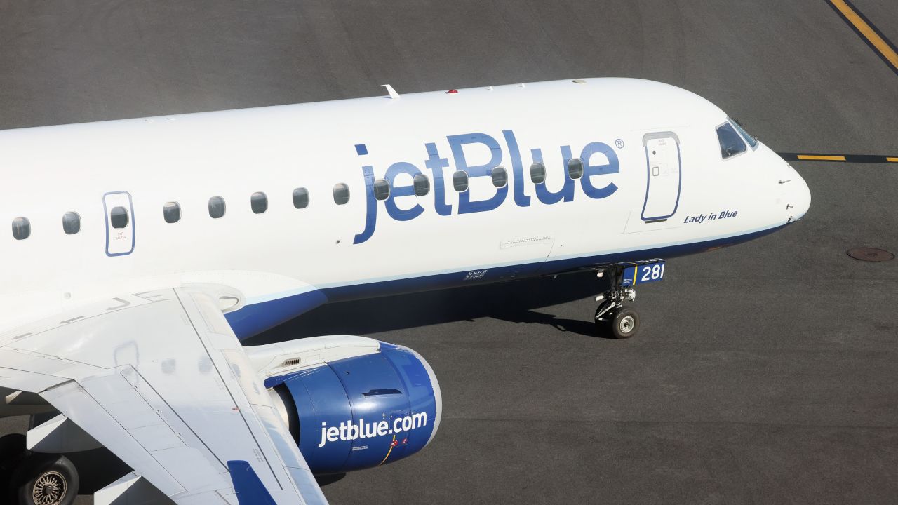 A JetBlue jet moves along the runway at Laguardia AIrport on November 10, 2022.
