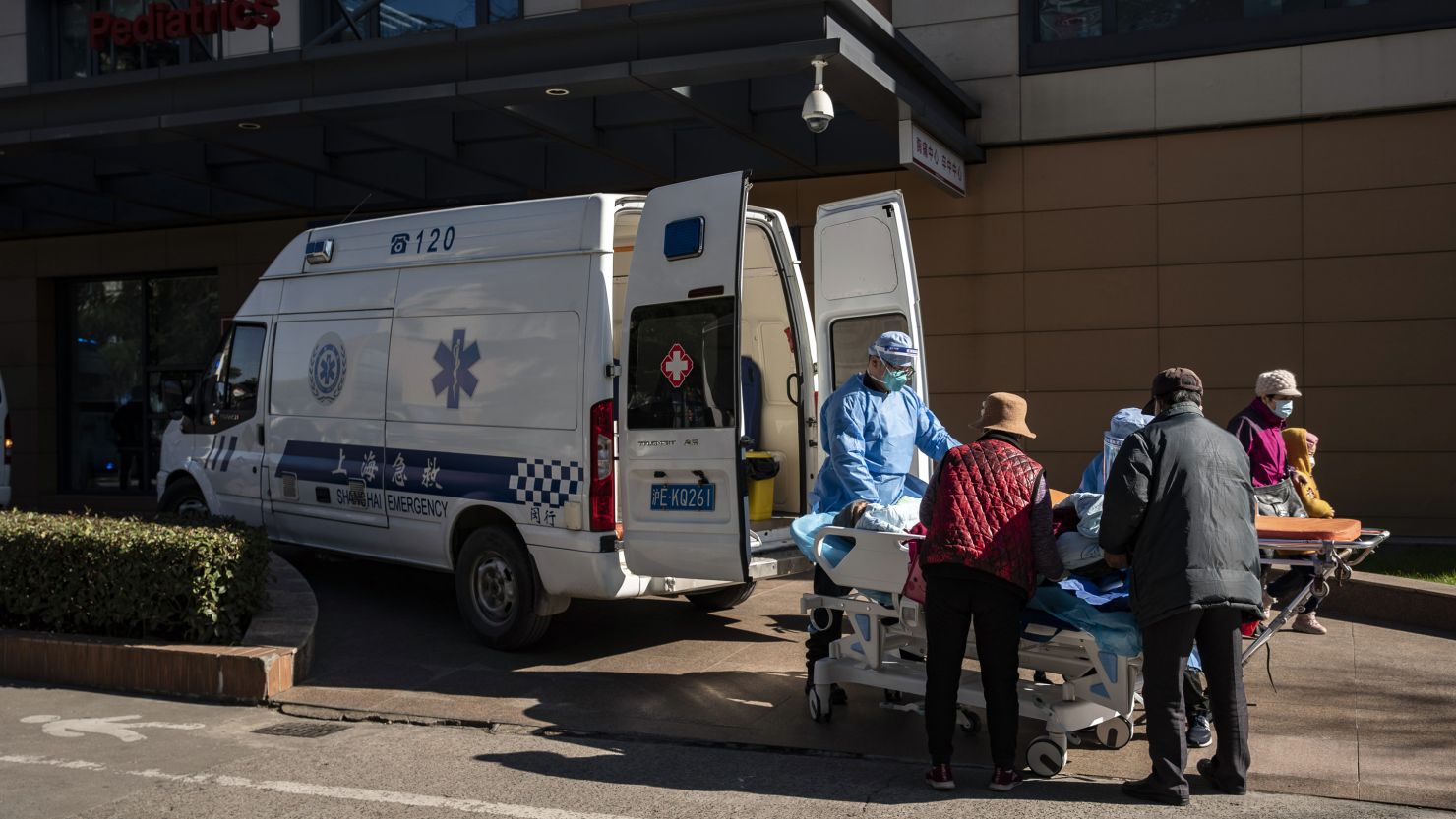 Health workers transport a patient into the emergency room of a hospital in Shanghai on Friday, December 23.