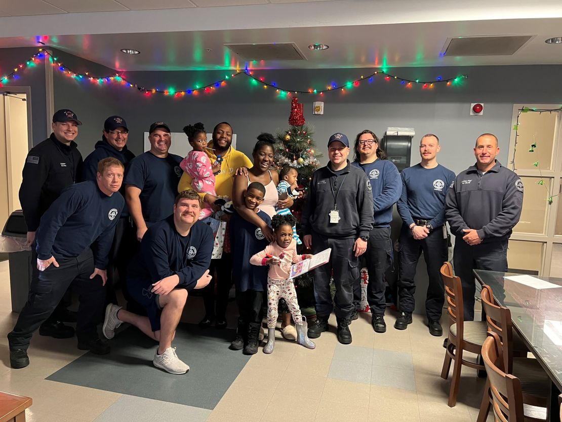 The rescued family poses with firefighters.