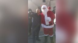 Geovanny Caripaz, 39, takes photo with Santa Claus on Christmas Day at a migrant shelter in El Paso, Texas.
