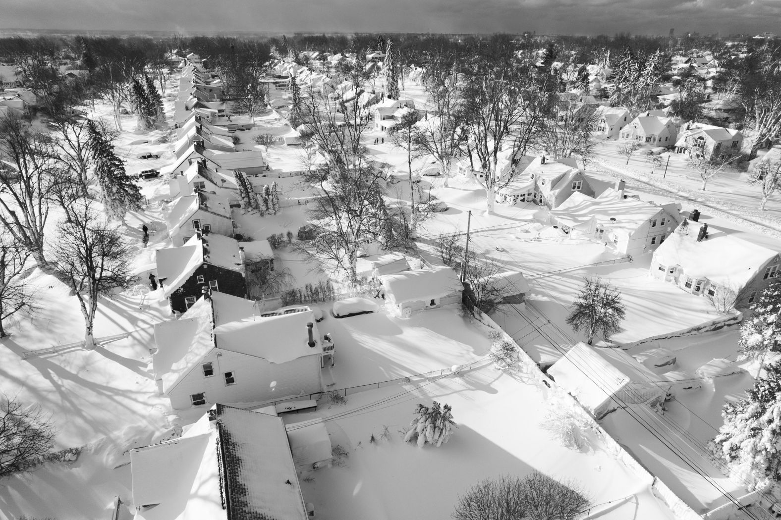 Snow blankets a neighborhood in Cheektowaga, New York, on Christmas Day. Western New York is <a href="index.php?page=&url=https%3A%2F%2Fwww.cnn.com%2F2022%2F12%2F26%2Fweather%2Farctic-winter-storm-new-york-blizzard-monday%2Findex.html" target="_blank">drowning in thick "lake effect" snow</a> -- which forms when cold air moves over the warm waters of the Great Lakes -- just one month after the region was slammed with a historic snowstorm.