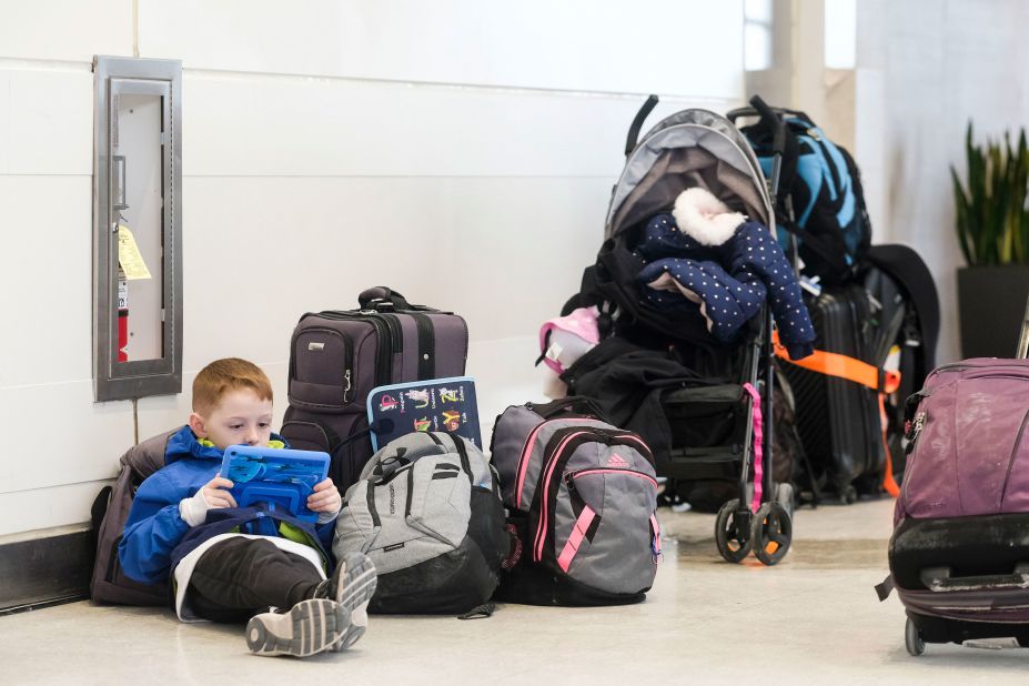 A young holiday traveler passes the time at Detroit Wayne County Metro Airport on December 24.
