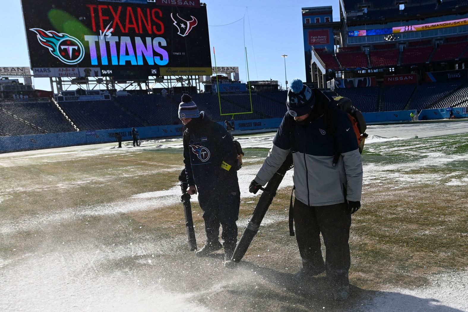 Nissan Stadium employees clear the field in Nashville before the an NFL football game on December 24.