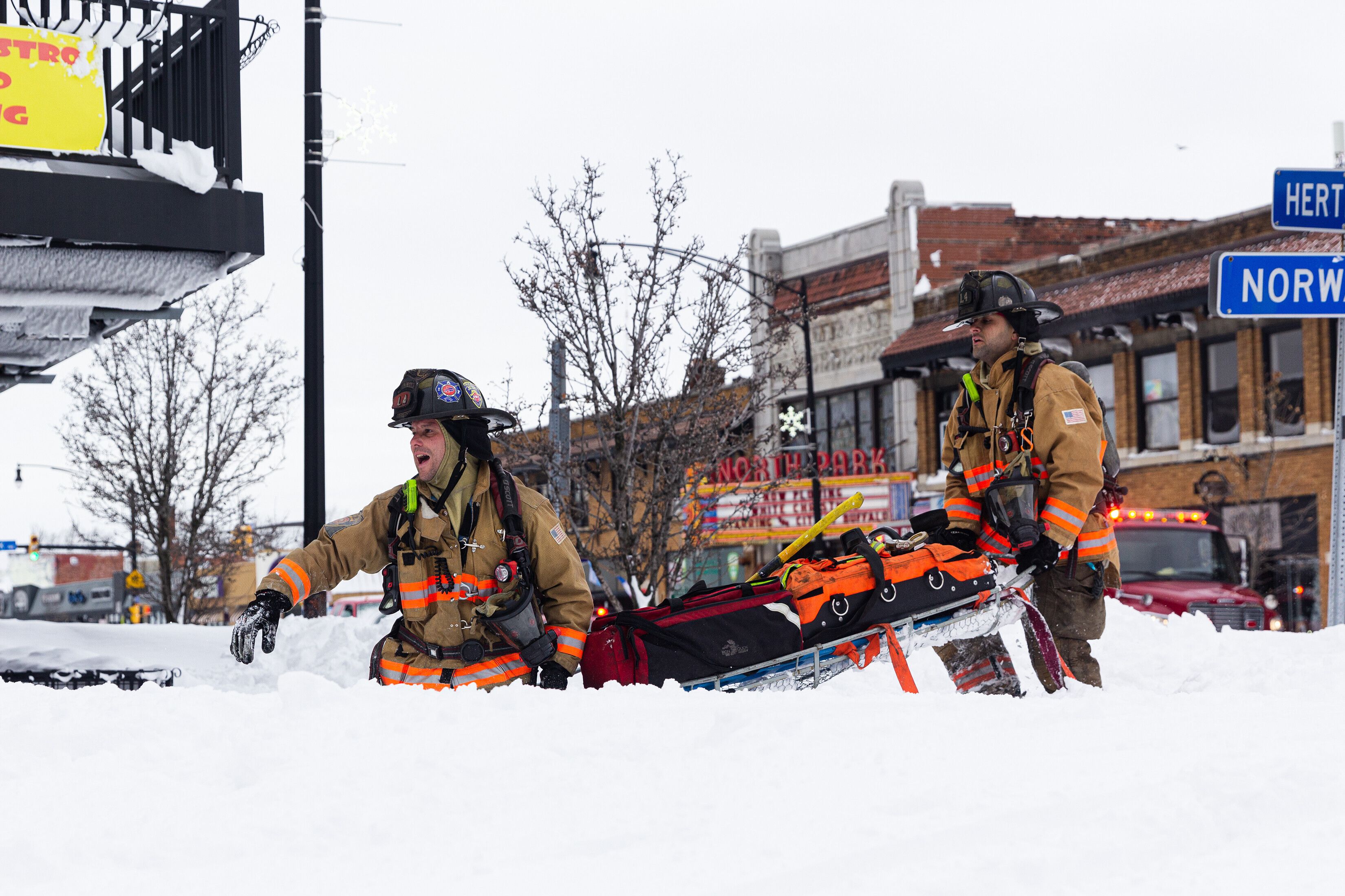 Firefighters respond to a fire on a snow-covered street in Buffalo on December 25.