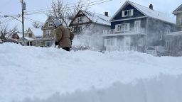A man clears snow from the front of his home, on Sunday, December 25, 2022, in Buffalo, NY 