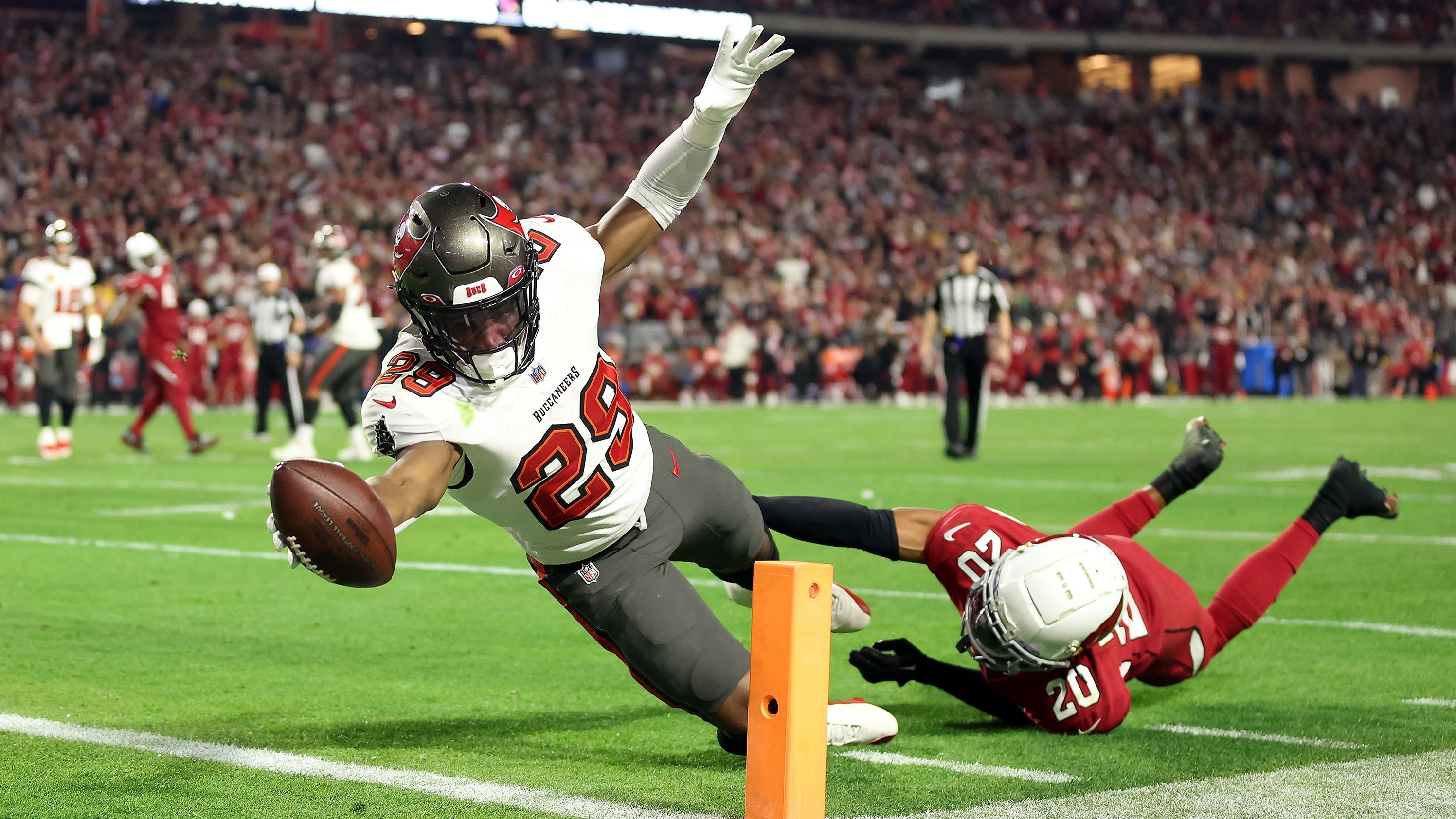 Rachaad White of the Tampa Bay Buccaneers stretches across the goal line for a touchdown as Marco Wilson of the Arizona Cardinals defends during the fourth quarter. The Bucs won 19-16.