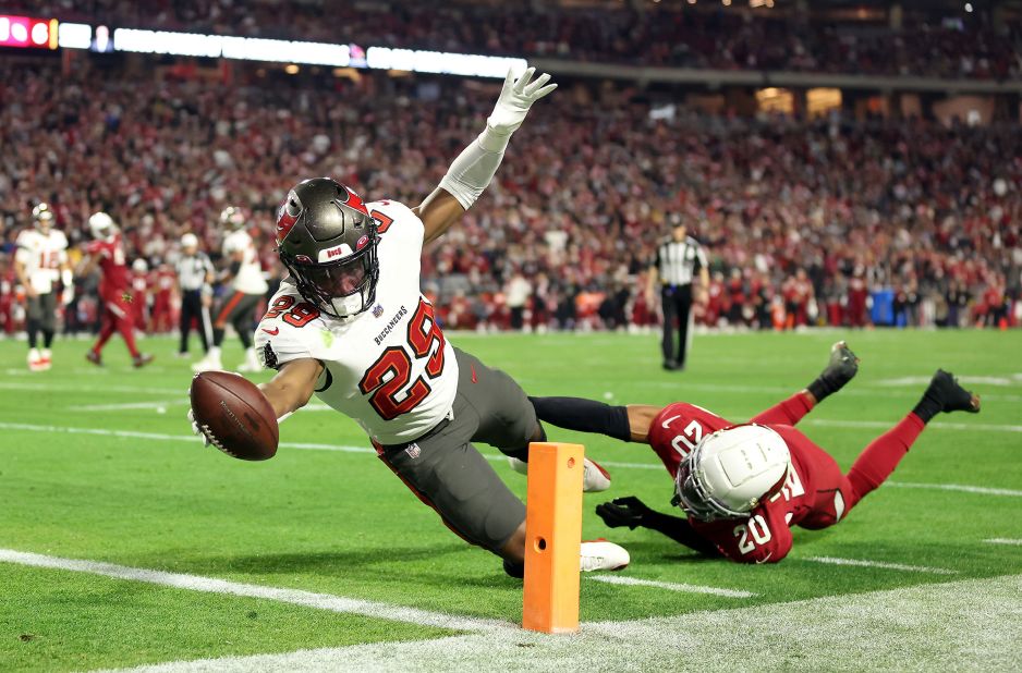Rachaad White of the Tampa Bay Buccaneers stretches across the goal line for a touchdown as Marco Wilson of the Arizona Cardinals defends during the fourth quarter. The Bucs won 19-16.