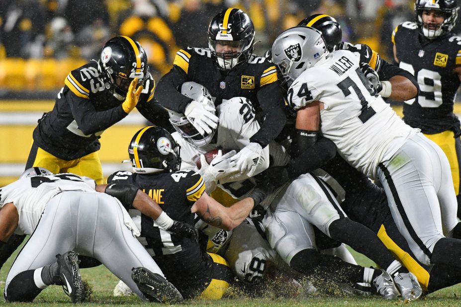 Las Vegas Raiders running back Josh Jacobs (28) is tackled during the second half of the game against the Pittsburgh Steelers. The Steelers won 13-10.