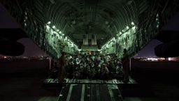 In this handout provided by the US Air Force, an air crew assigned to the 816th Expeditionary Airlift Squadron assists evacuees aboard a C-17 Globemaster III aircraft in support of the Afghanistan evacuation at Hamid Karzai International Airport on August 21, 2021 in Kabul, Afghanistan.