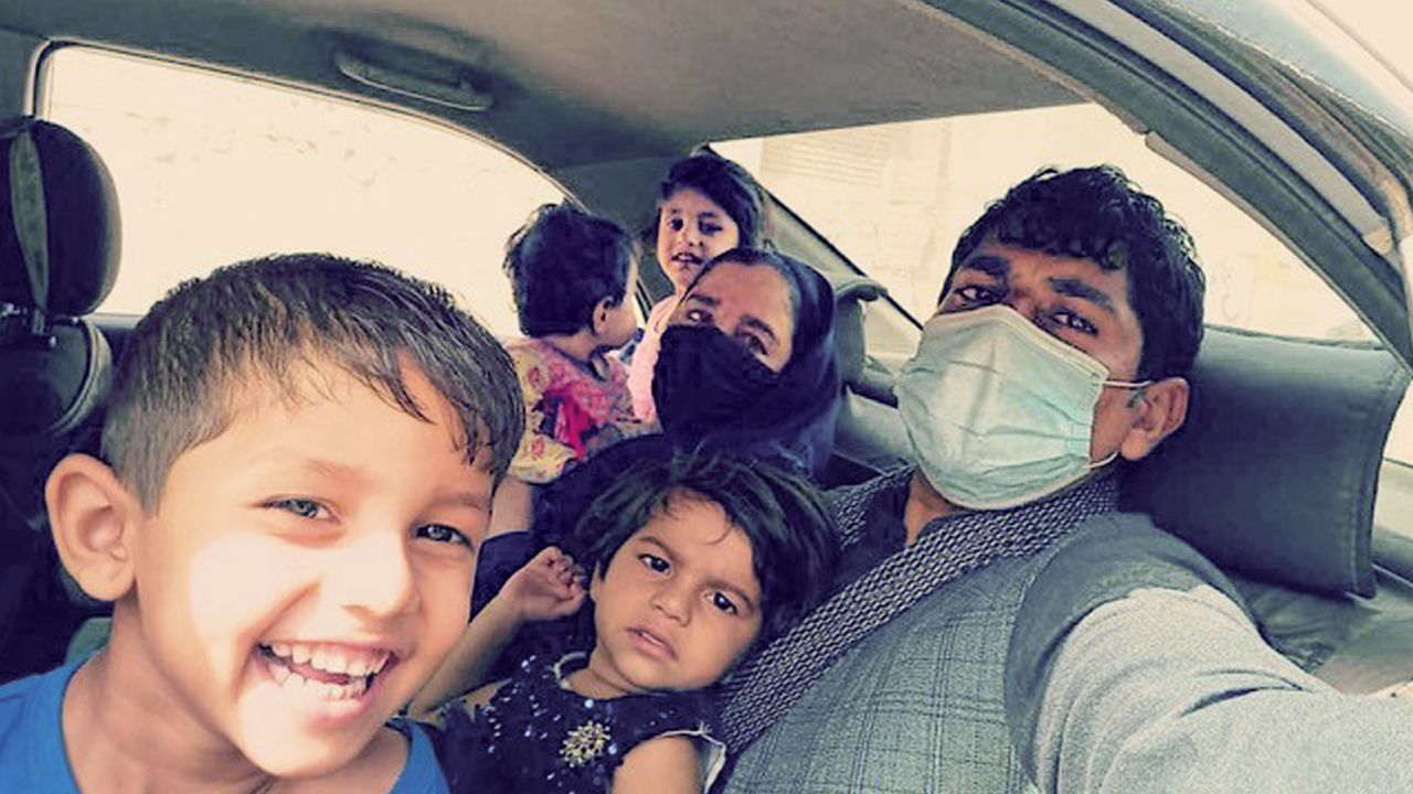 Zainullah Zaki and his family on August 18, 2021, after they made it to Hamid Karzai International Airport to evacuate Afghanistan.