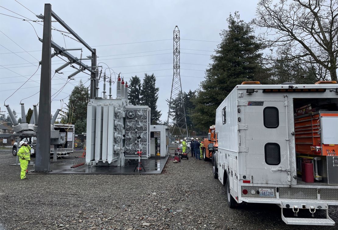 A Tacoma Power crew works at an electrical substation damaged by vandals on Sunday, December 25, 2022, in Graham, Washington.