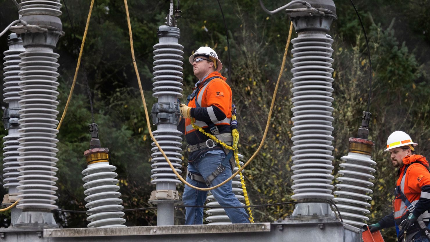 A Tacoma Power crew works at an electrical substation damaged by vandals early on Christmas morning, Sunday, December 25, 2022, in Graham, Washington.
