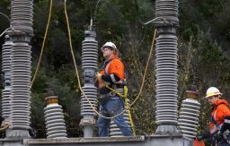 A Tacoma Power crew works at an electrical substation damaged by vandals early on Christmas morning, Sunday, Dec. 25, 2022, in Graham, Washington. 