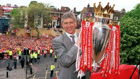 Wenger holds the Premier League trophy at Islington Town Hall May 19, 2004.