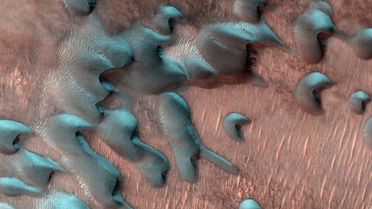 The Mars Reconnaissance Orbiter captured an image of frost-covered Martian dunes far north of the equator two days after the winter solstice arrived on Mars in July. 