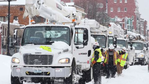 Utility trucks line up in Buffalo, N.Y., after an ongoing snowstorm on Dec. 26, 2022, where thousands are still without power. 